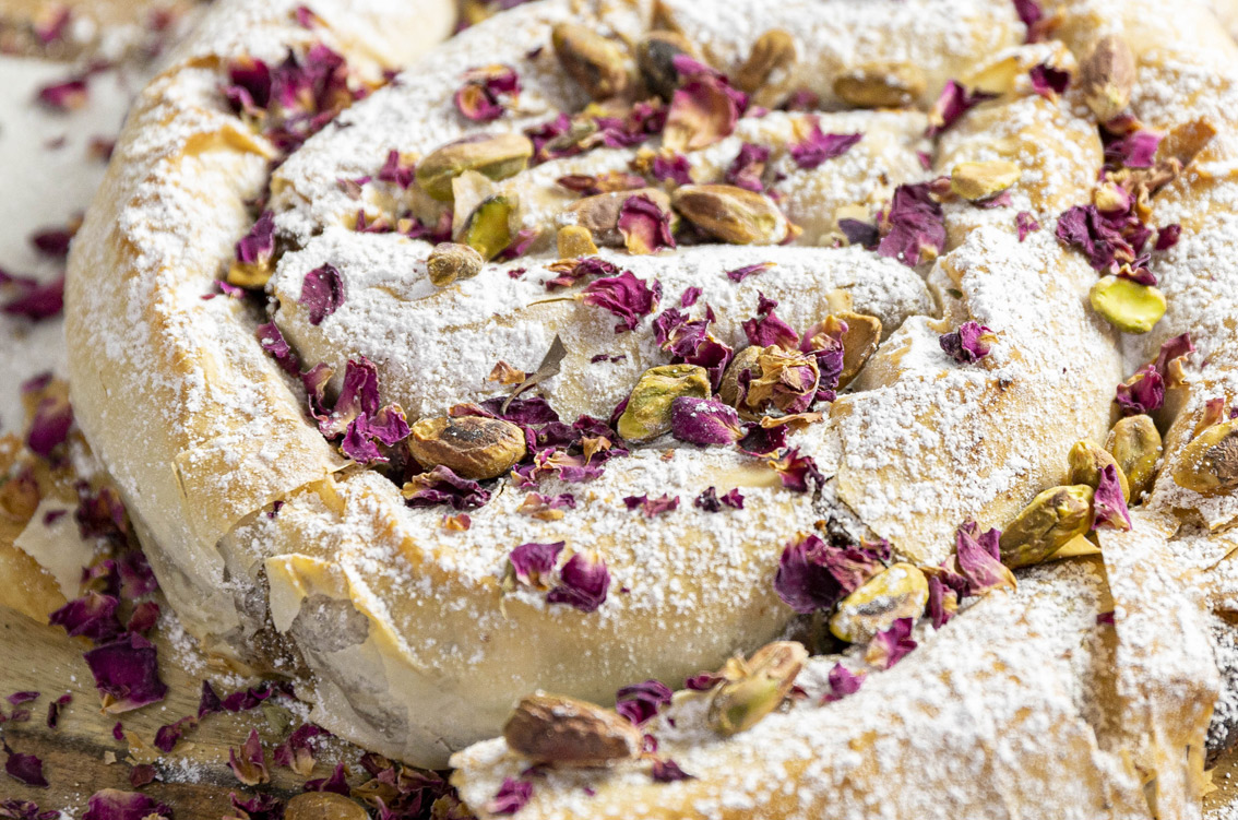 Close up of delicious roll up with pistachio nut and rose petals on top