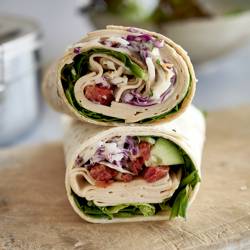 A close up shot of a chicken and salad wrap.