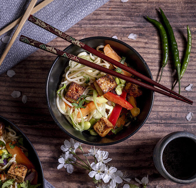 An image of a stir-fry with noodles, and crispy fried tofu.