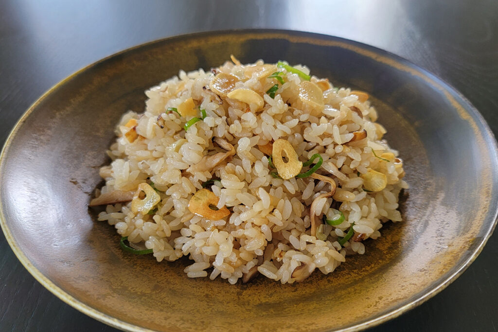 A bowl of rice topped with crispy fried garlic.