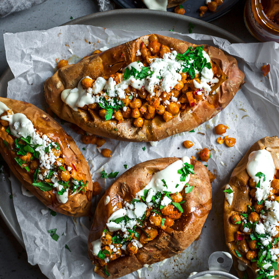 Delicious looking baked sweet potato with cheese and herbs on top