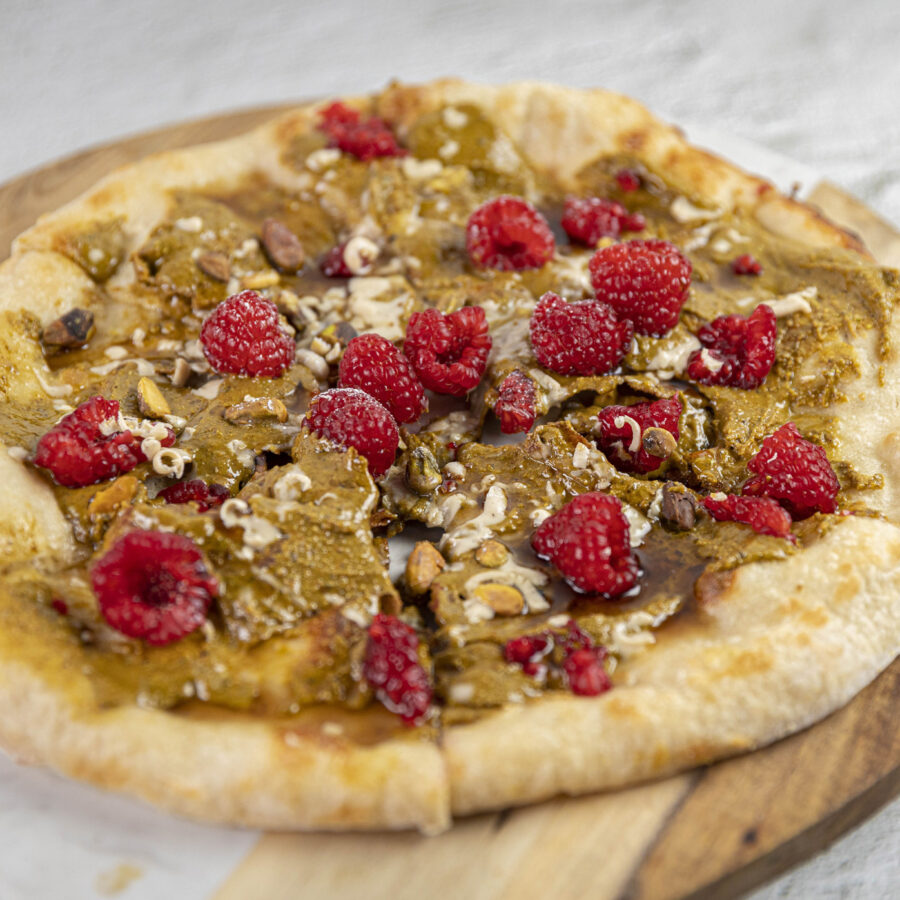yummy looking vegan pizza with white chocolate and red berries