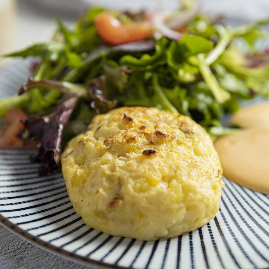 vegan gnocchi on plate with green salad on side